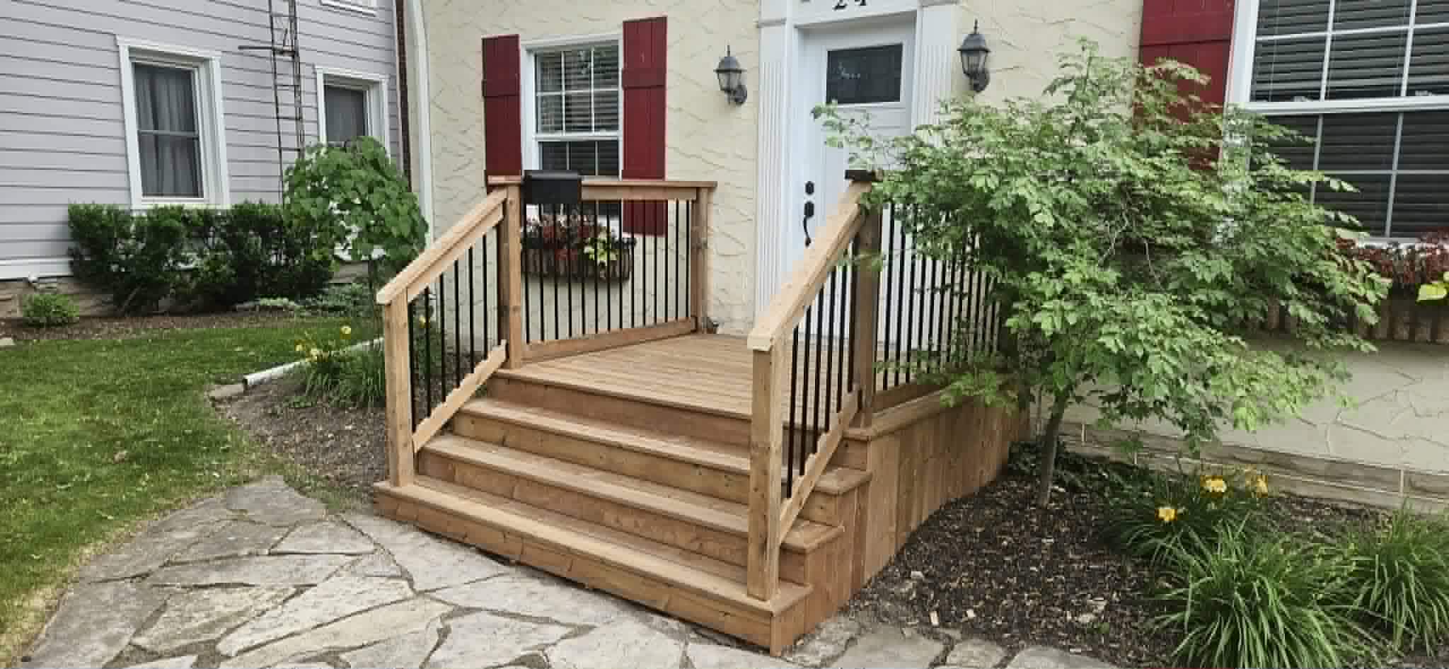 Finished front porch steps with wood and black metal railings